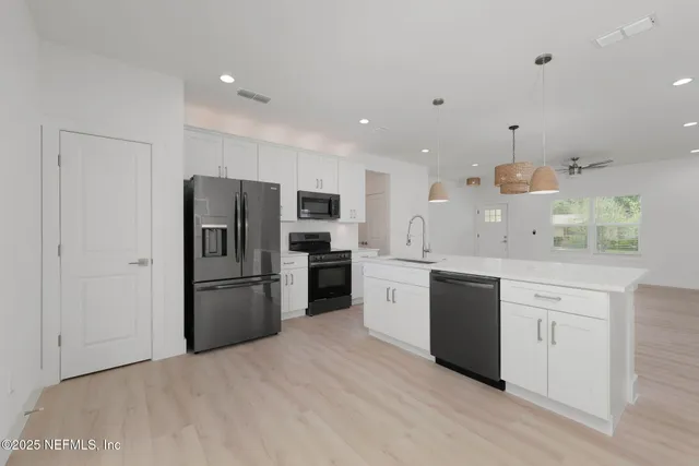 a kitchen with a refrigerator and a sink