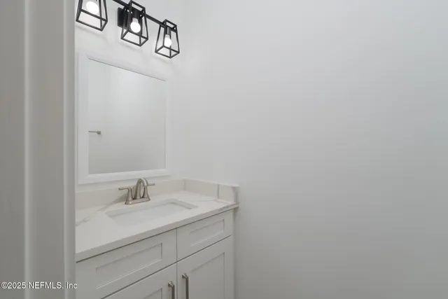 a bathroom with a sink and vanity