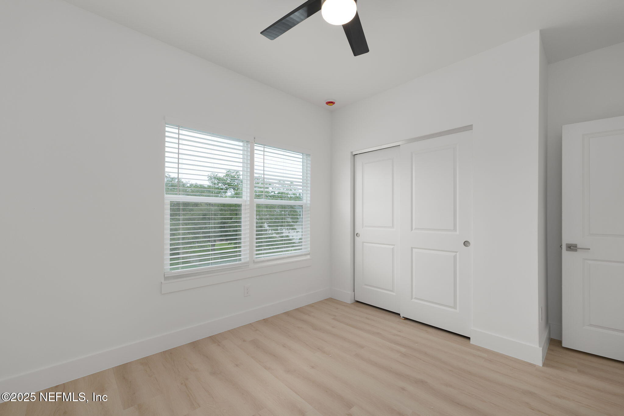 609 Twenty Second Street St. Augustine, FL 32084 - Photo 27 of 34 a view of an empty room with a window and wooden floor