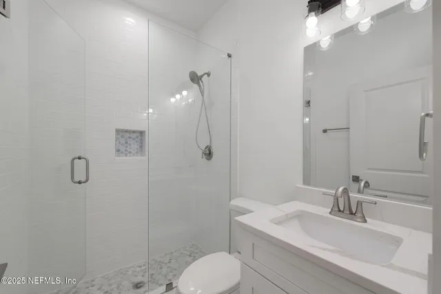 a bathroom with a granite countertop sink a toilet and bathtub