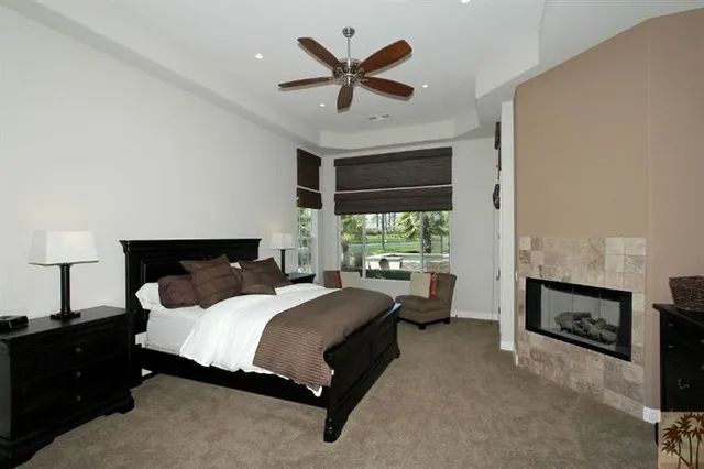 a bedroom with a bed and a large window