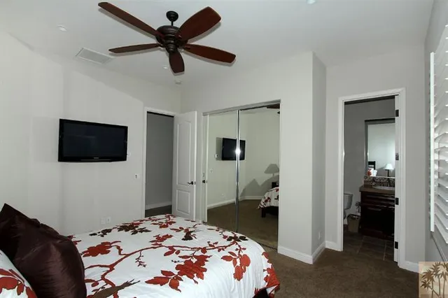 a bedroom with a bed and a television