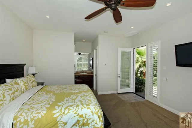 a bedroom with a bed and a flat tv screen