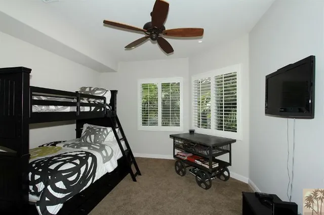 a bedroom with a bed and a flat tv screen