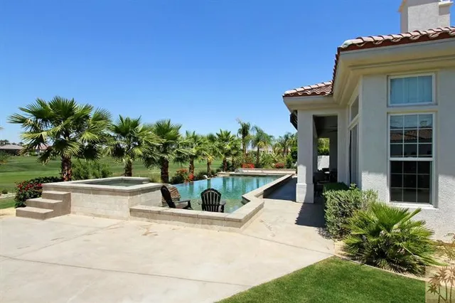 a view of a house with potted plants