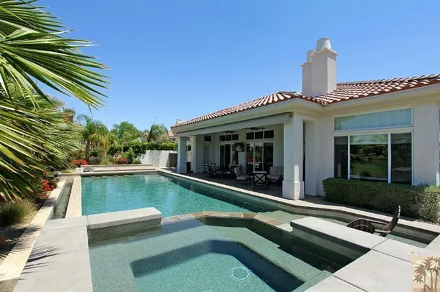 a view of swimming pool with chairs
