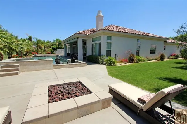 a view of a backyard with sitting area