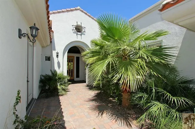 a view of a entrance of the house with a small yard