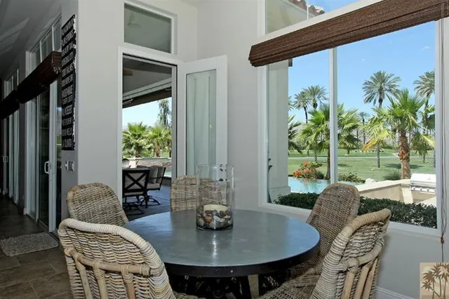 a view of a dining room with furniture and a potted plant