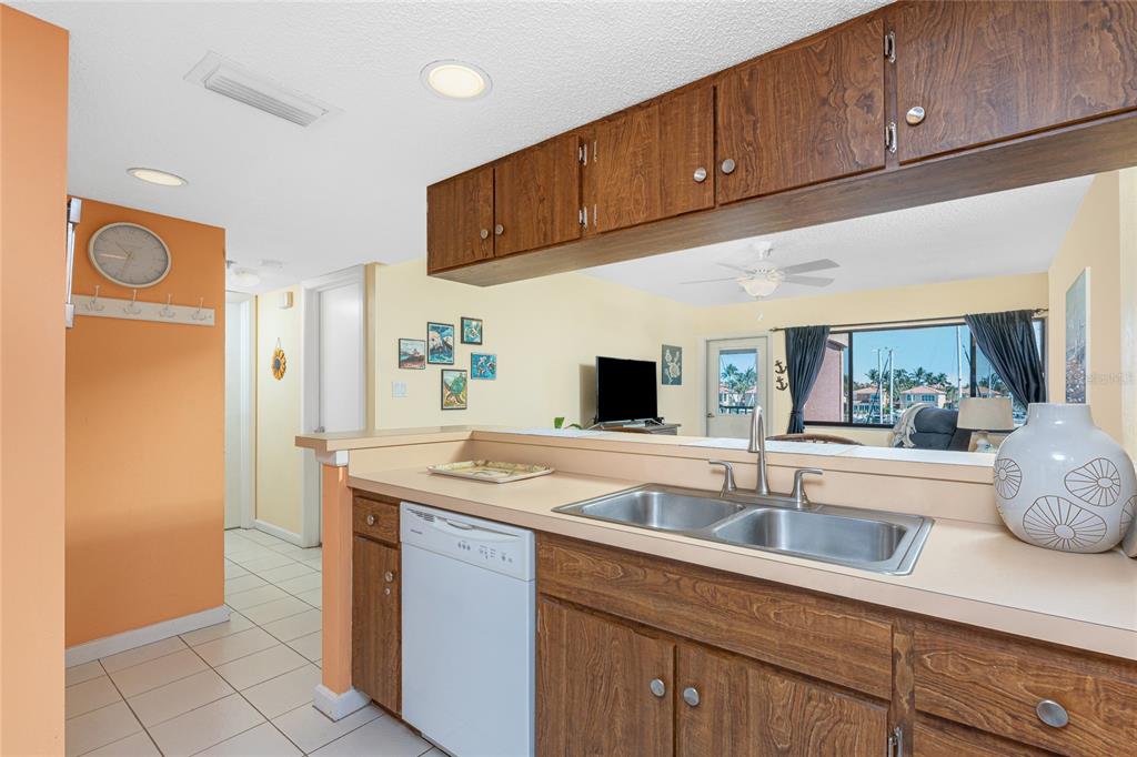 3160 Matecumbe Key Road, Unit 238 Punta Gorda, FL 33955 - Photo 14 of 41 a kitchen with stainless steel appliances granite countertop a sink and a refrigerator