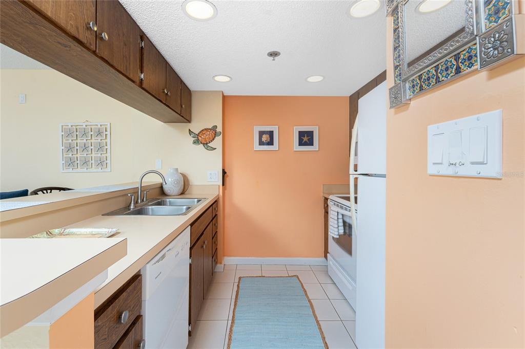 3160 Matecumbe Key Road, Unit 238 Punta Gorda, FL 33955 - Photo 15 of 41 a kitchen with a sink and a refrigerator