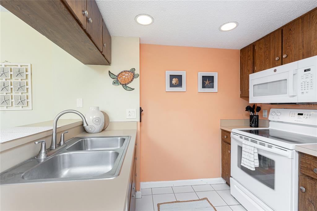 3160 Matecumbe Key Road, Unit 238 Punta Gorda, FL 33955 - Photo 16 of 41 a kitchen with sink a stove and washer