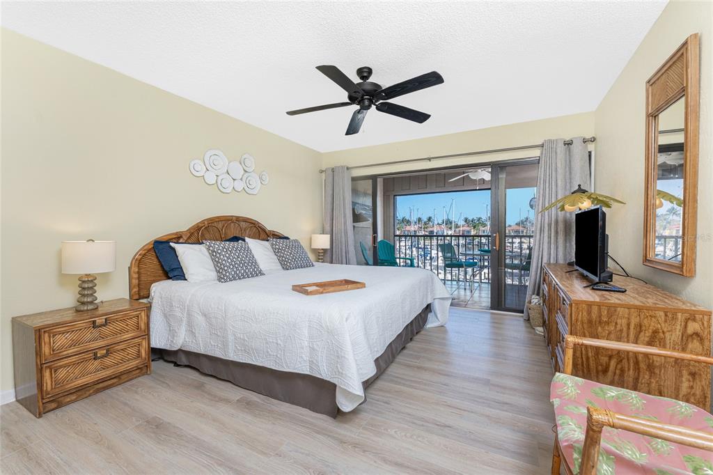 3160 Matecumbe Key Road, Unit 238 Punta Gorda, FL 33955 - Photo 5 of 41 a bedroom with a bed and wooden floor