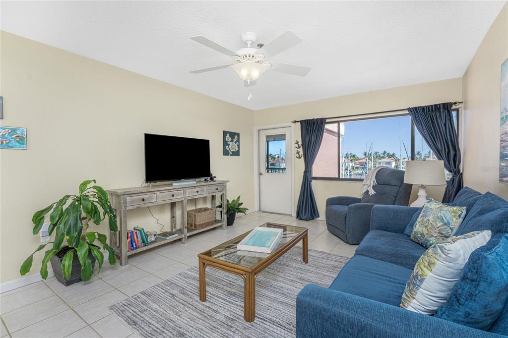 3160 Matecumbe Key Road, Unit 238 Punta Gorda, FL 33955 - Photo 10 of 41 a living room with furniture and a flat screen tv