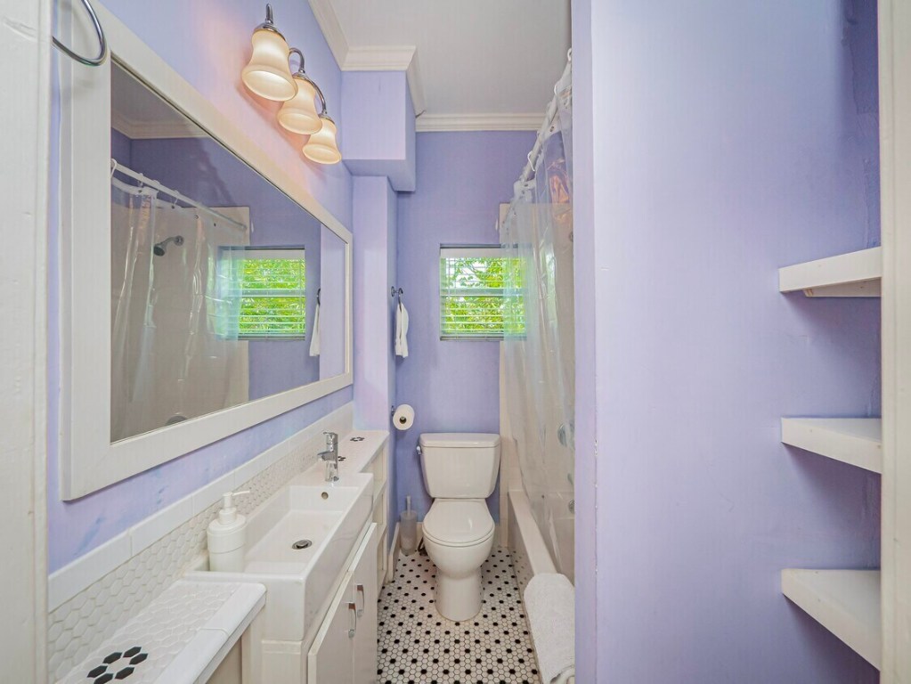 1159 Navasota Street Austin, TX 78702 - Photo 11 of 23 a bathroom with a sink a toilet and a bathtub