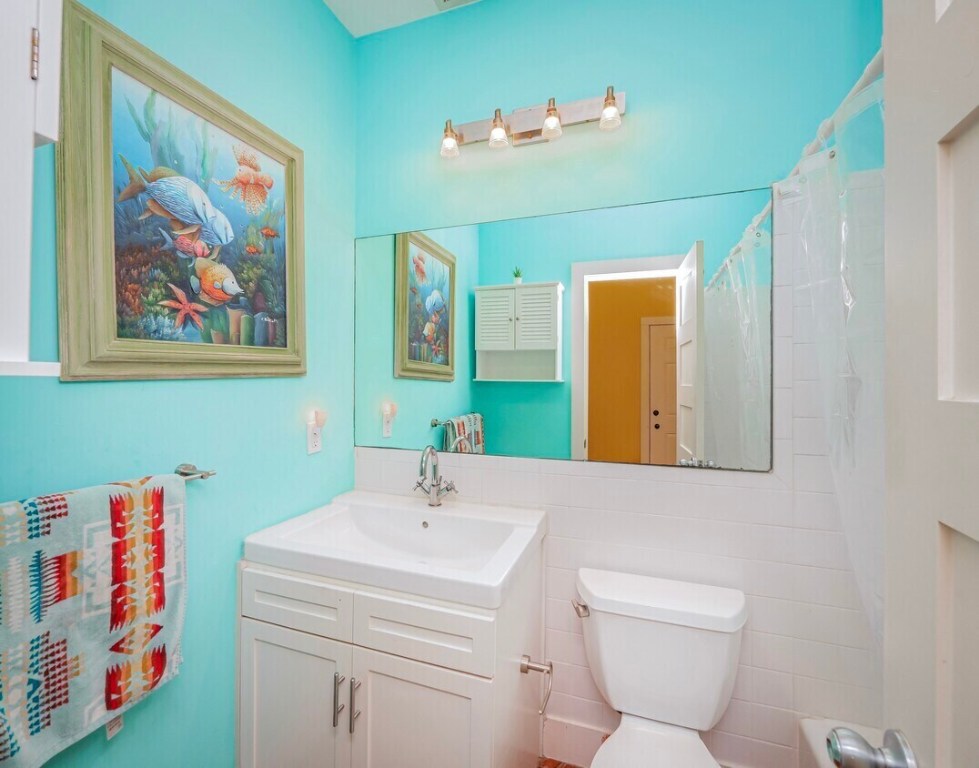 1159 Navasota Street Austin, TX 78702 - Photo 22 of 23 a bathroom with a sink mirror and toilet