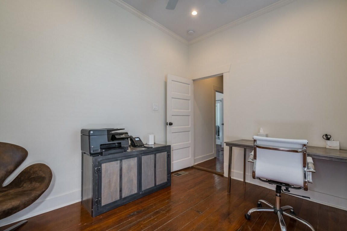 1159 Navasota Street Austin, TX 78702 - Photo 4 of 23 a view of a workspace with furniture and wooden floor