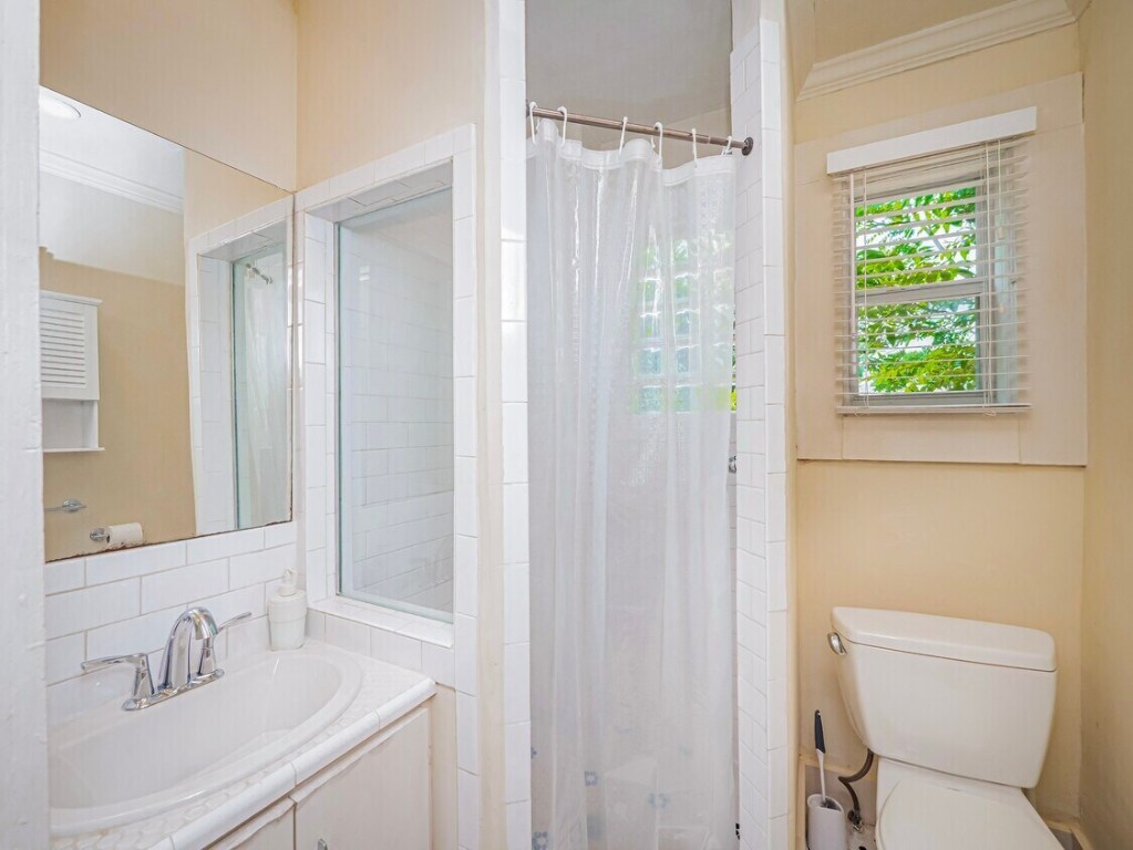 1159 Navasota Street Austin, TX 78702 - Photo 7 of 23 a bathroom with a sink toilet and shower