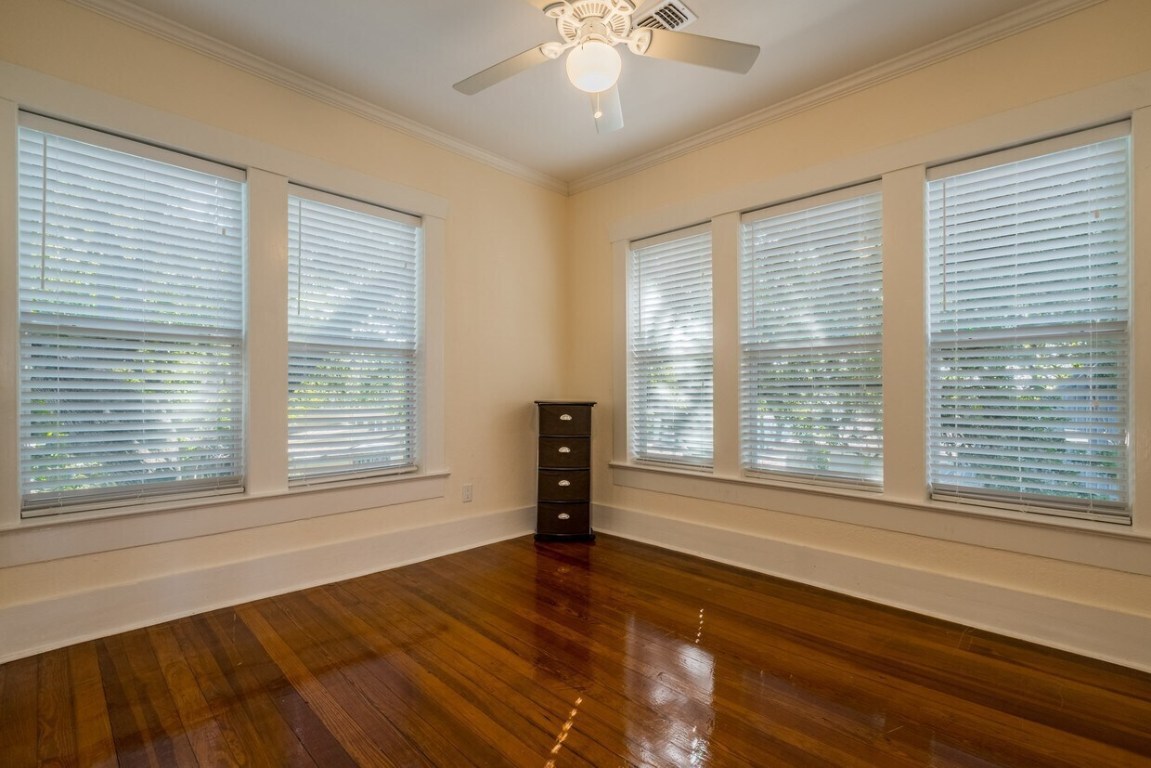 1159 Navasota Street Austin, TX 78702 - Photo 9 of 23 a view of an empty room with a window and wooden floor