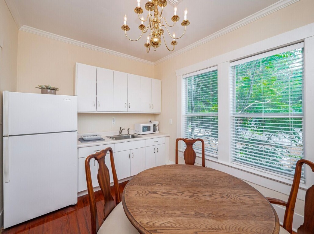 1159 Navasota Street Austin, TX 78702 - Photo 10 of 23 a bed sitting in a kitchen with window and cabinets