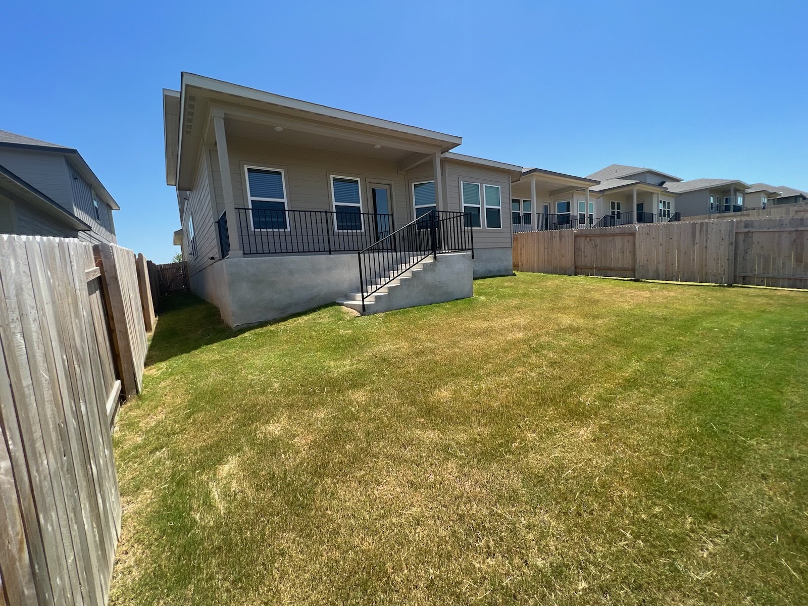 6400 Rounded Pebble Lane Buda, TX 78610 - Photo 28 of 34 a view of a house with a backyard and a small yard