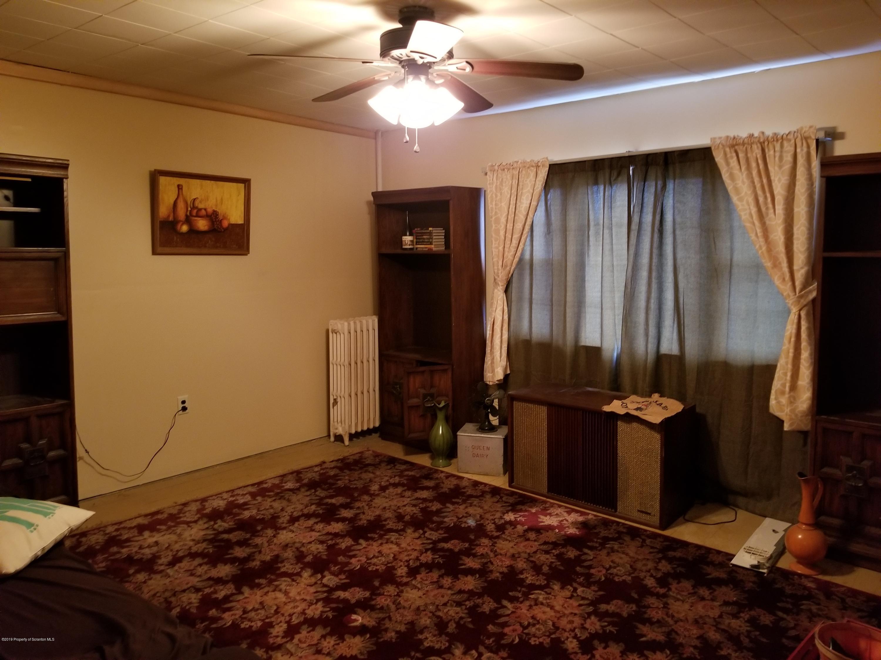 1719 Ash Street Scranton, PA 18510 - Photo 14 of 19 a bedroom with a bed and a chandelier