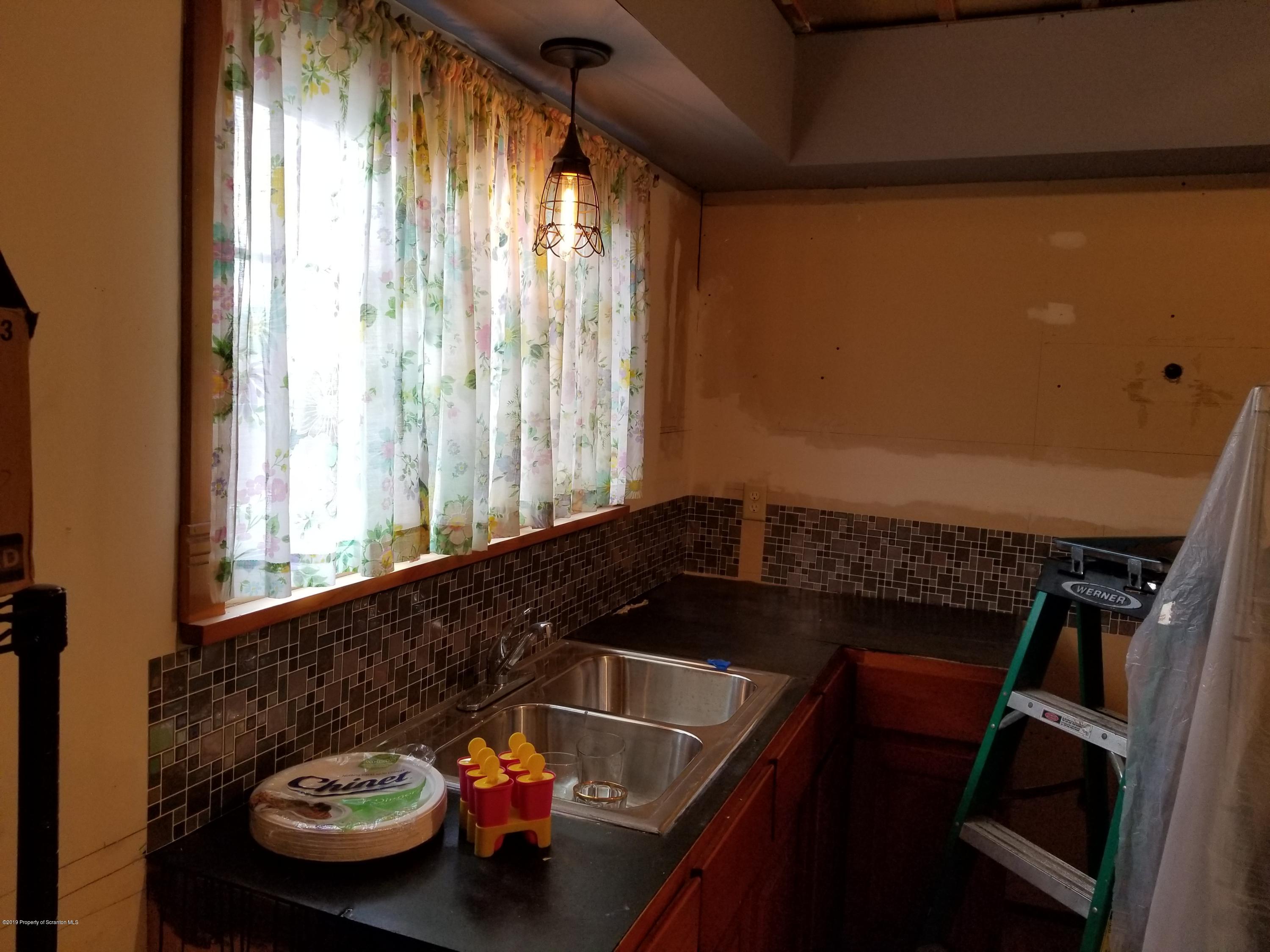 1719 Ash Street Scranton, PA 18510 - Photo 18 of 19 a bathroom with a sink and a mirror