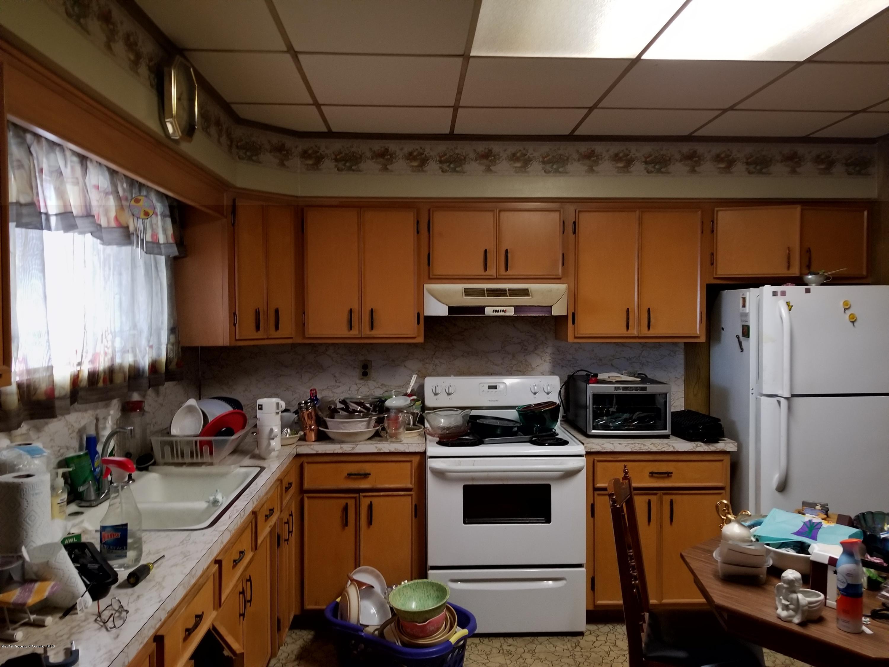 1719 Ash Street Scranton, PA 18510 - Photo 4 of 19 a kitchen with a sink a stove and cabinets