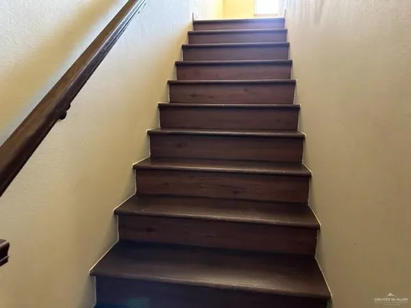 a view of backyard with wooden fence