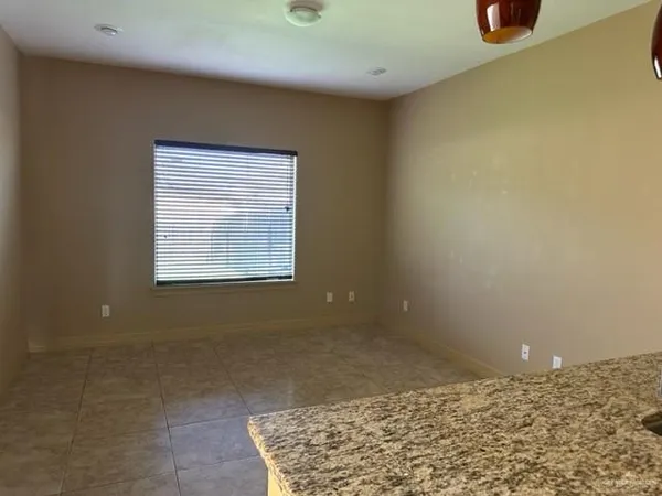 a kitchen with stainless steel appliances granite countertop a sink a refrigerator and a counter space