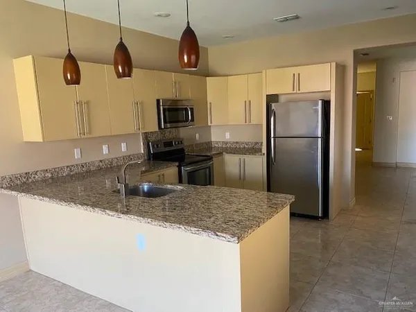 a view of a livingroom with wooden floor and a ceiling fan