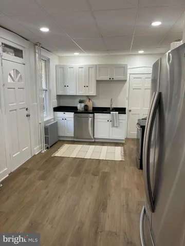 a kitchen with stainless steel appliances granite countertop a refrigerator and a stove