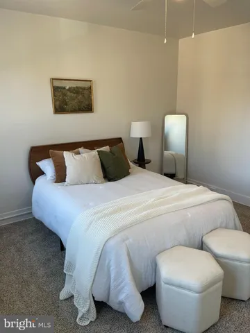 a bed room with a bed and a chair