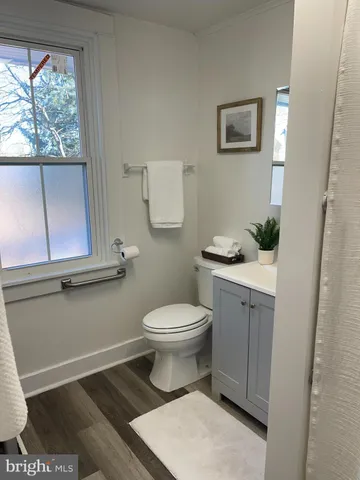 a bathroom with a toilet a sink and a window