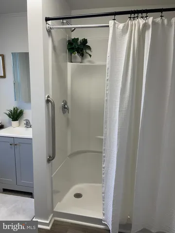 a bathroom with a shower and a sink