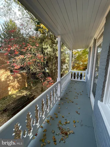 a view of a balcony with wooden floor