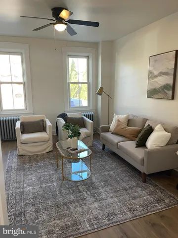 a living room with furniture and a potted plant