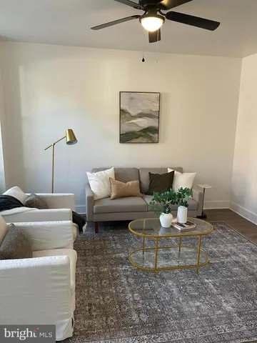 a living room with furniture and a rug
