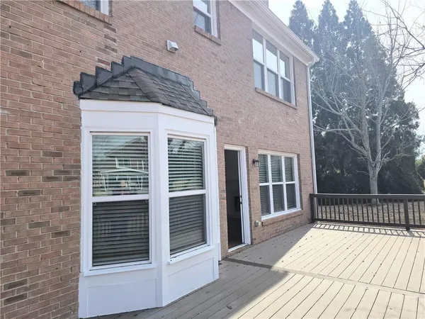 a view of a brick house with a large window