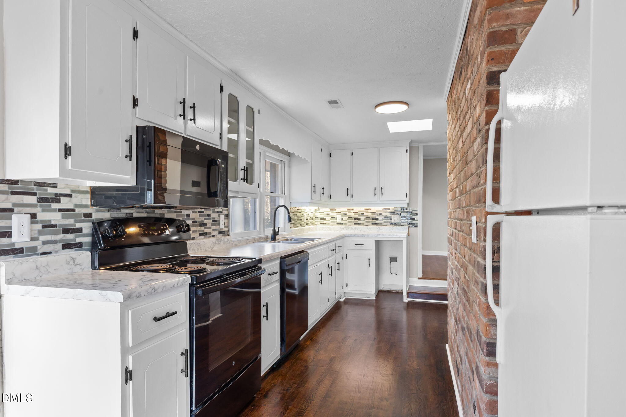 6522 Blake Street Stedman, NC 28391 - Photo 12 of 52 a kitchen with cabinets stainless steel appliances and wooden floor