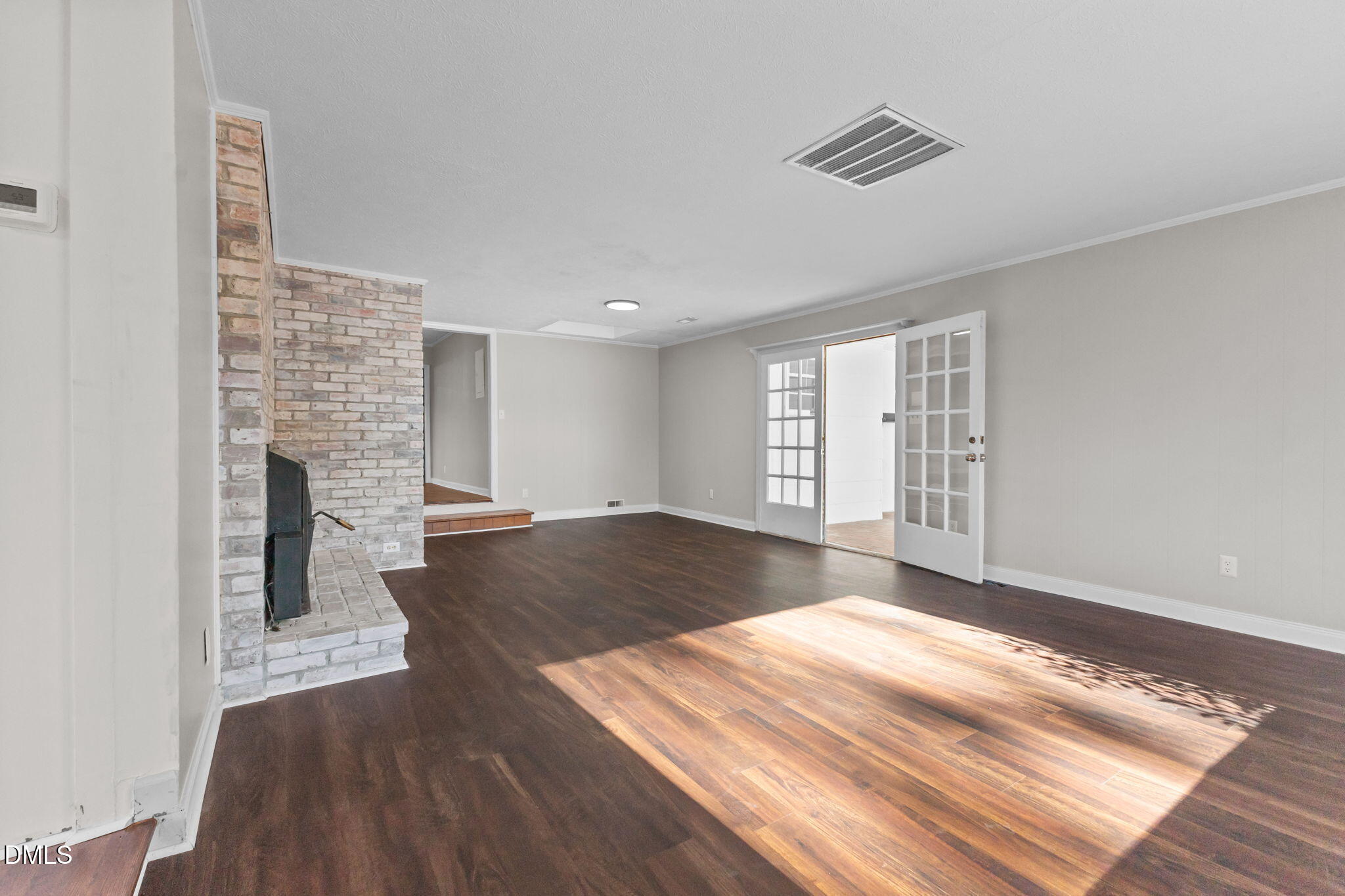 6522 Blake Street Stedman, NC 28391 - Photo 16 of 52 a view of an empty room with a window and wooden floor