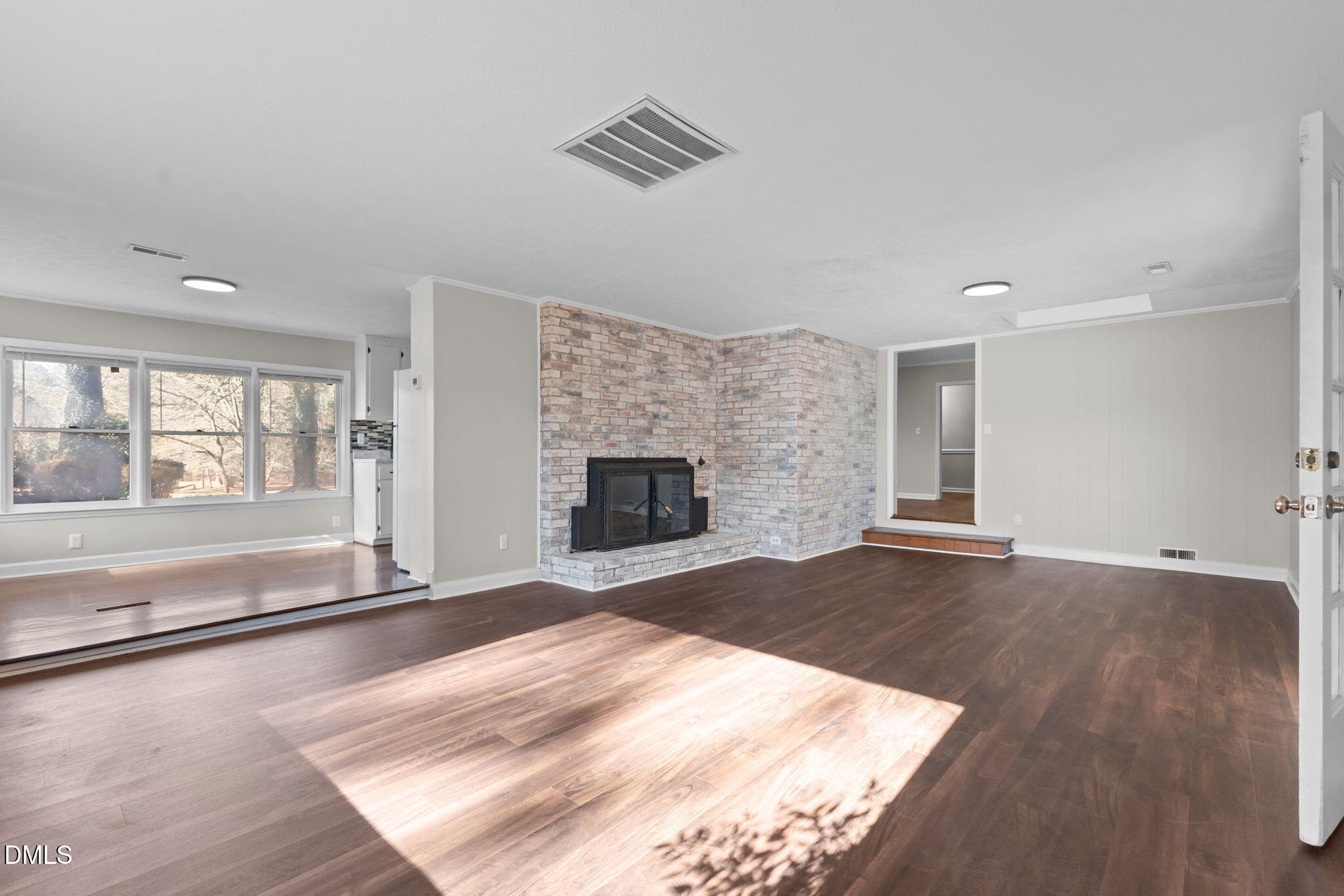 6522 Blake Street Stedman, NC 28391 - Photo 17 of 52 an empty room with wooden floor and fireplace