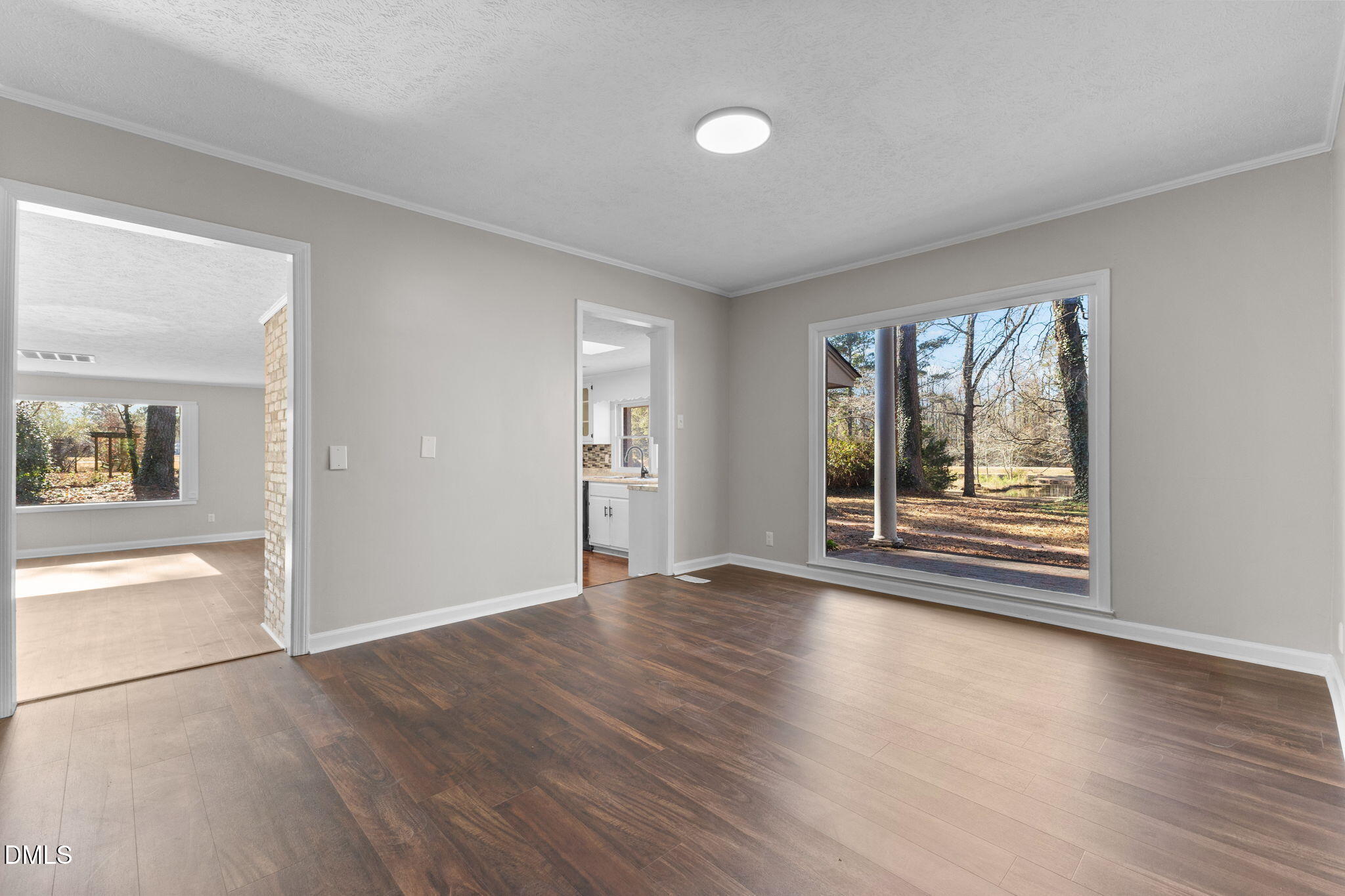 6522 Blake Street Stedman, NC 28391 - Photo 20 of 52 an empty room with wooden floor and windows