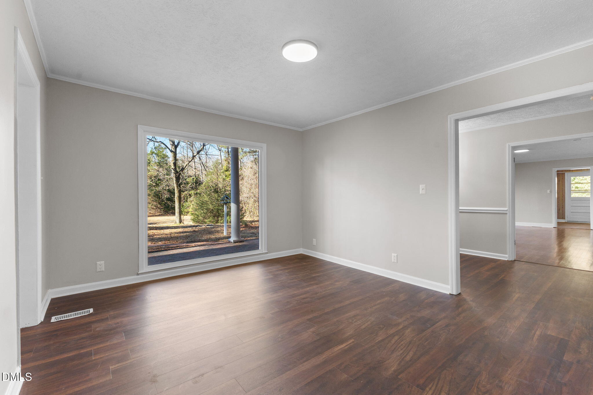 6522 Blake Street Stedman, NC 28391 - Photo 21 of 52 a view of an empty room with wooden floor and a window