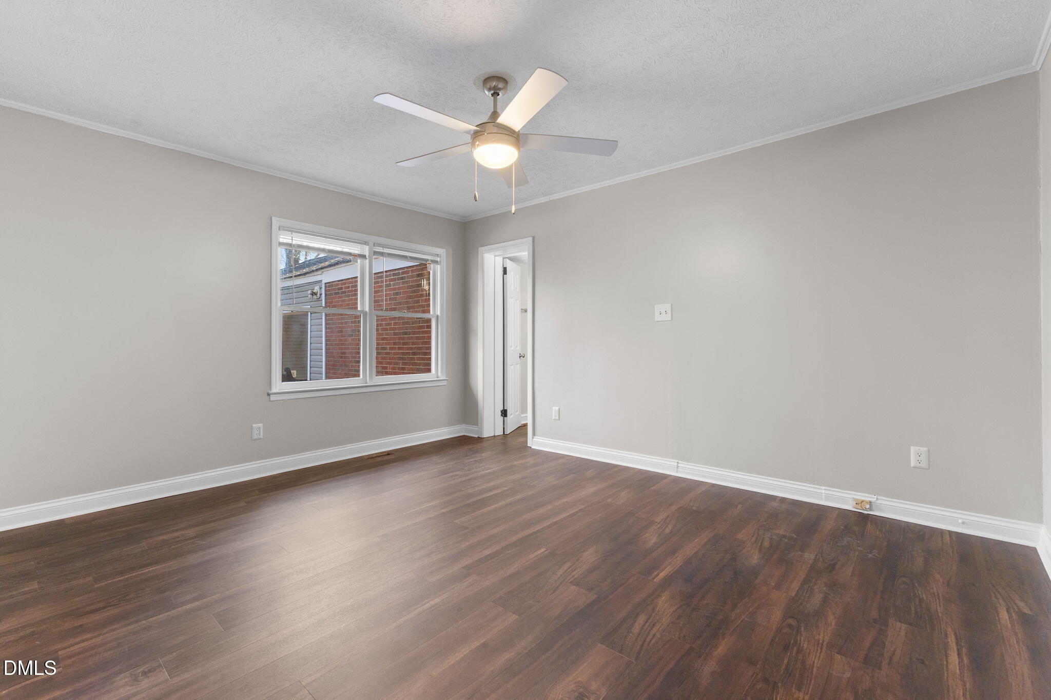 6522 Blake Street Stedman, NC 28391 - Photo 27 of 52 an empty room with wooden floor chandelier fan and windows