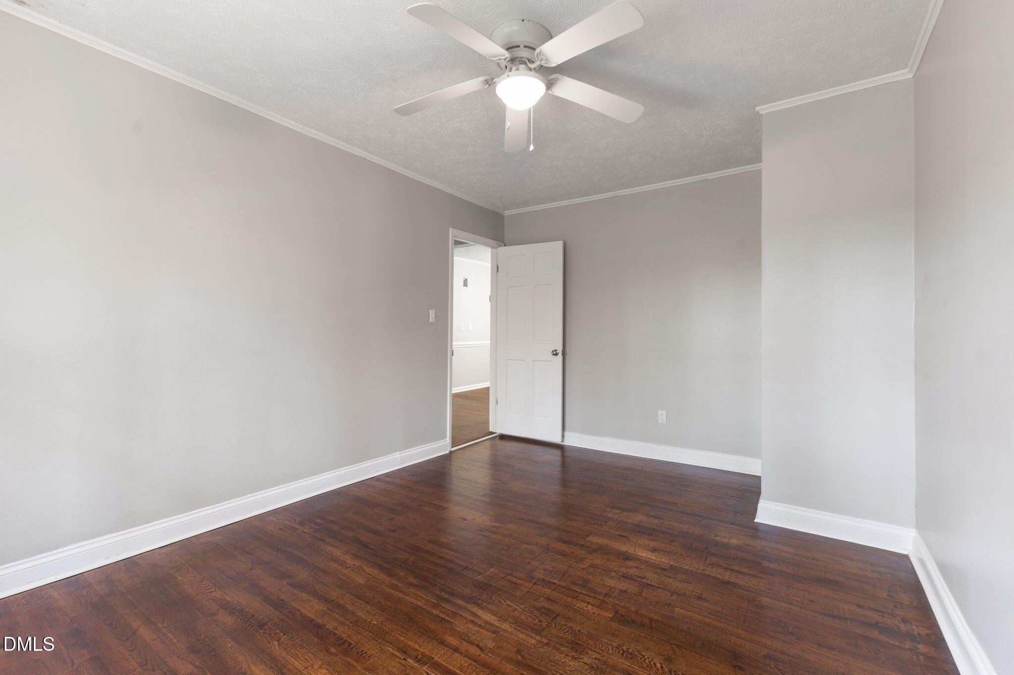 6522 Blake Street Stedman, NC 28391 - Photo 31 of 52 an empty room with wooden floor and a ceiling fan