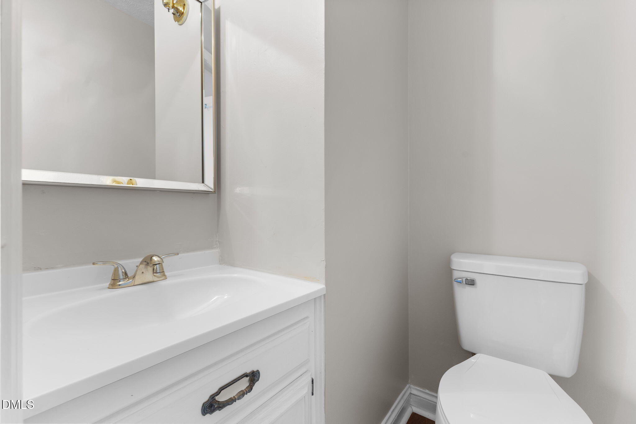 6522 Blake Street Stedman, NC 28391 - Photo 35 of 52 a bathroom with a toilet sink and mirror