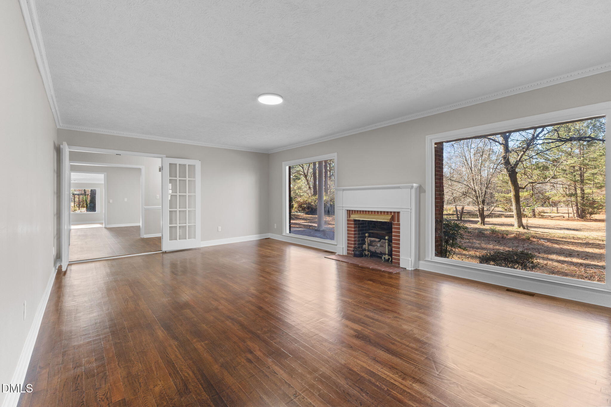 6522 Blake Street Stedman, NC 28391 - Photo 9 of 52 wooden floor fireplace and windows in an empty room