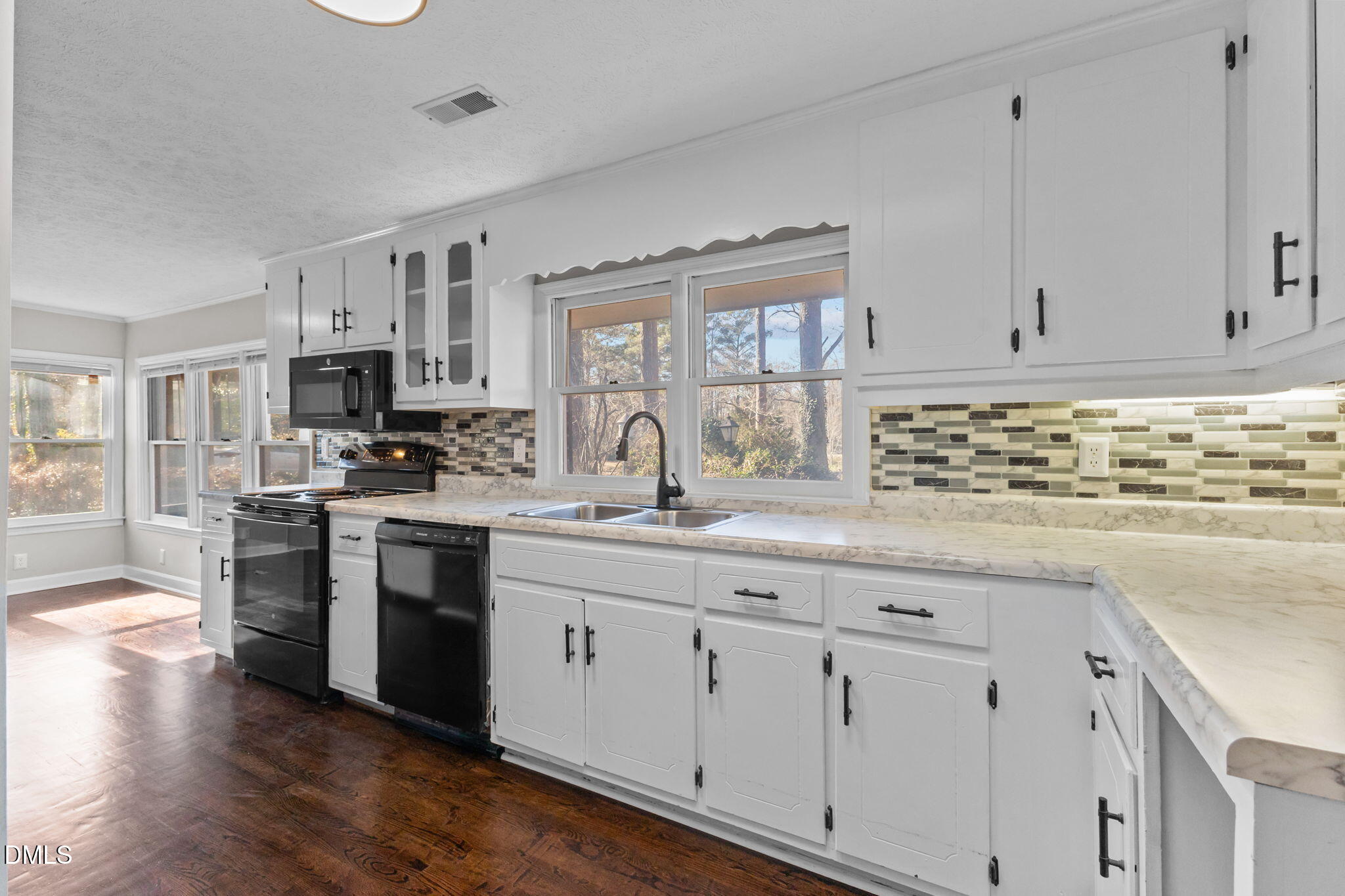 6522 Blake Street Stedman, NC 28391 - Photo 10 of 52 a kitchen with cabinets appliances a sink and a window