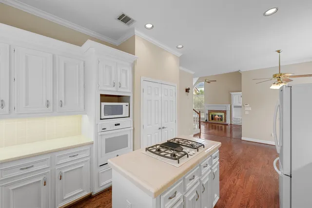 an empty room with wooden floor a fireplace and a window